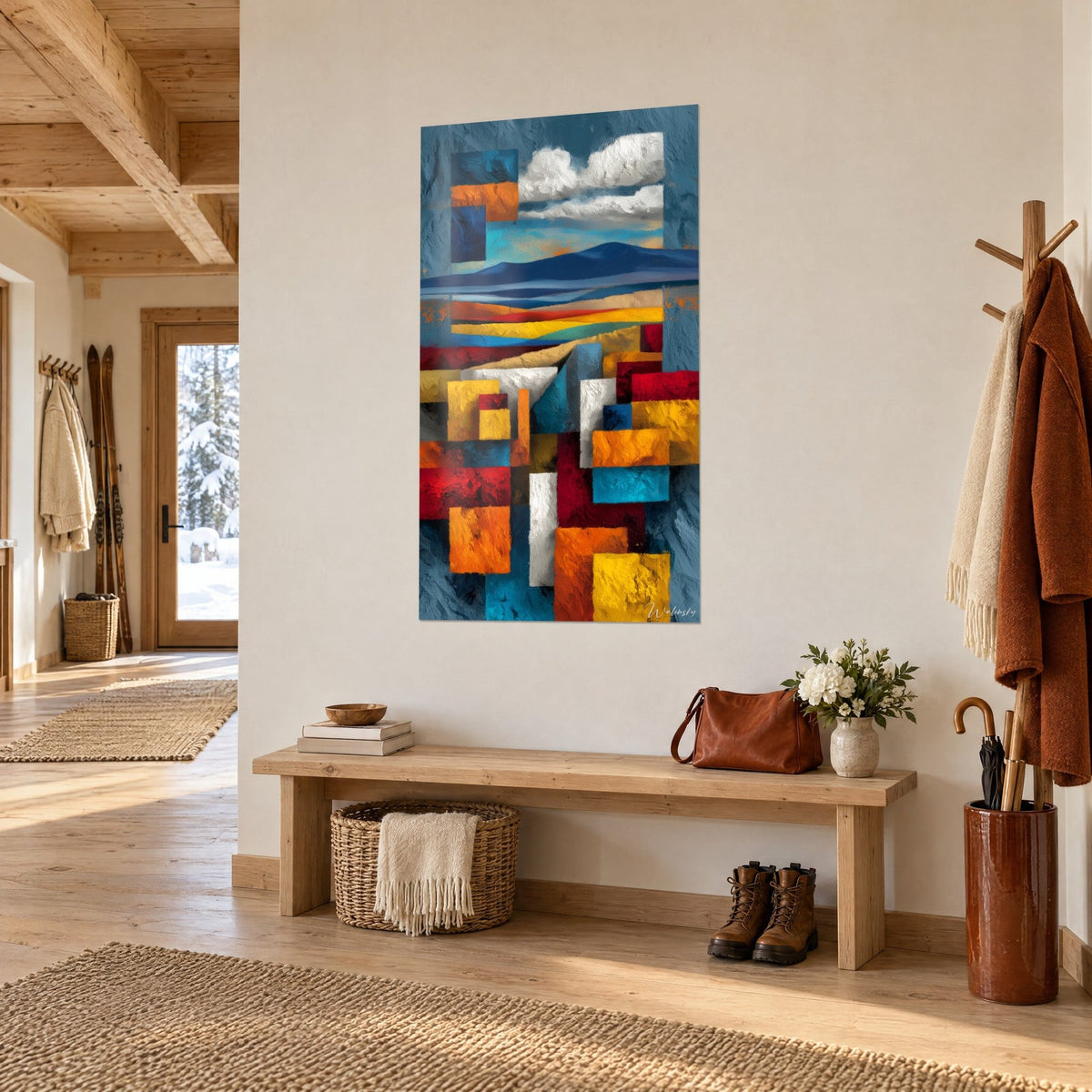 Wall art of a desert landscape in flat geometric shapes of petrol blue and ochre, white clouds, hung in a light wood chalet entrance