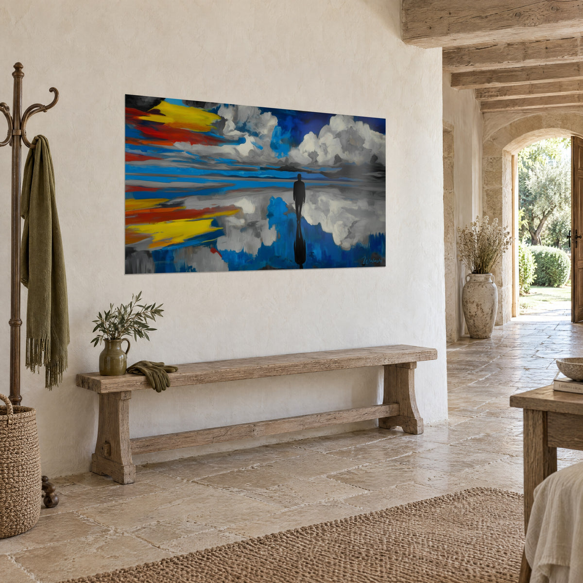 Wall art black silhouette facing the horizon, reflections of grey and white cumulus clouds, deep blue and bright red, rough plaster wall of a stone house