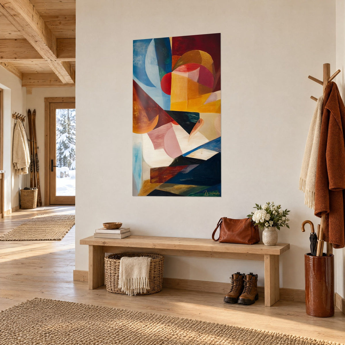 Wall art ochre, burgundy and midnight blue triangular shapes, hung beside a wooden bench in the entrance of a chalet