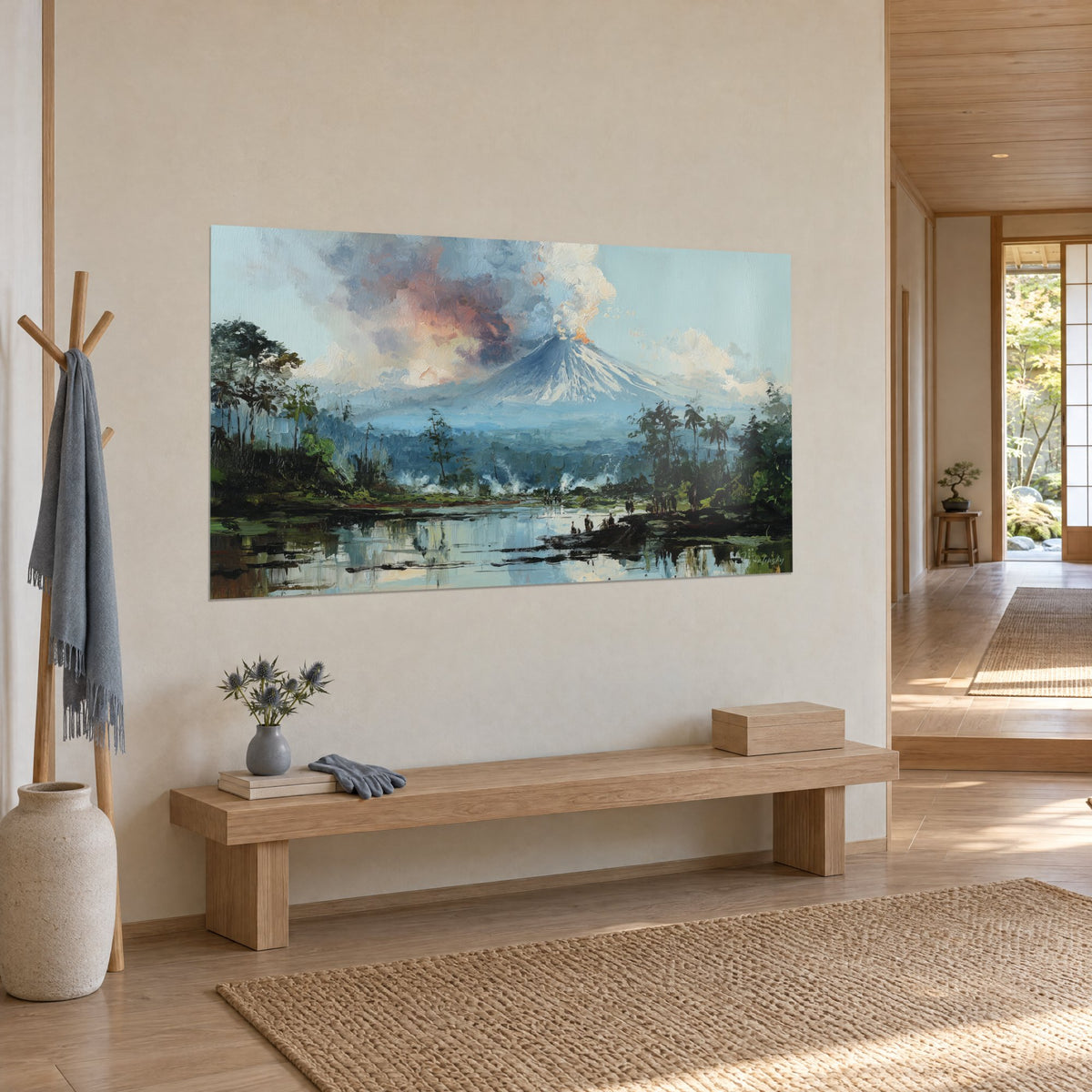 Wall art of an orange smoke plume rising from a blue-tinged peak, green palm trees and shimmering water, hung in a japandi hallway in three-quarter view