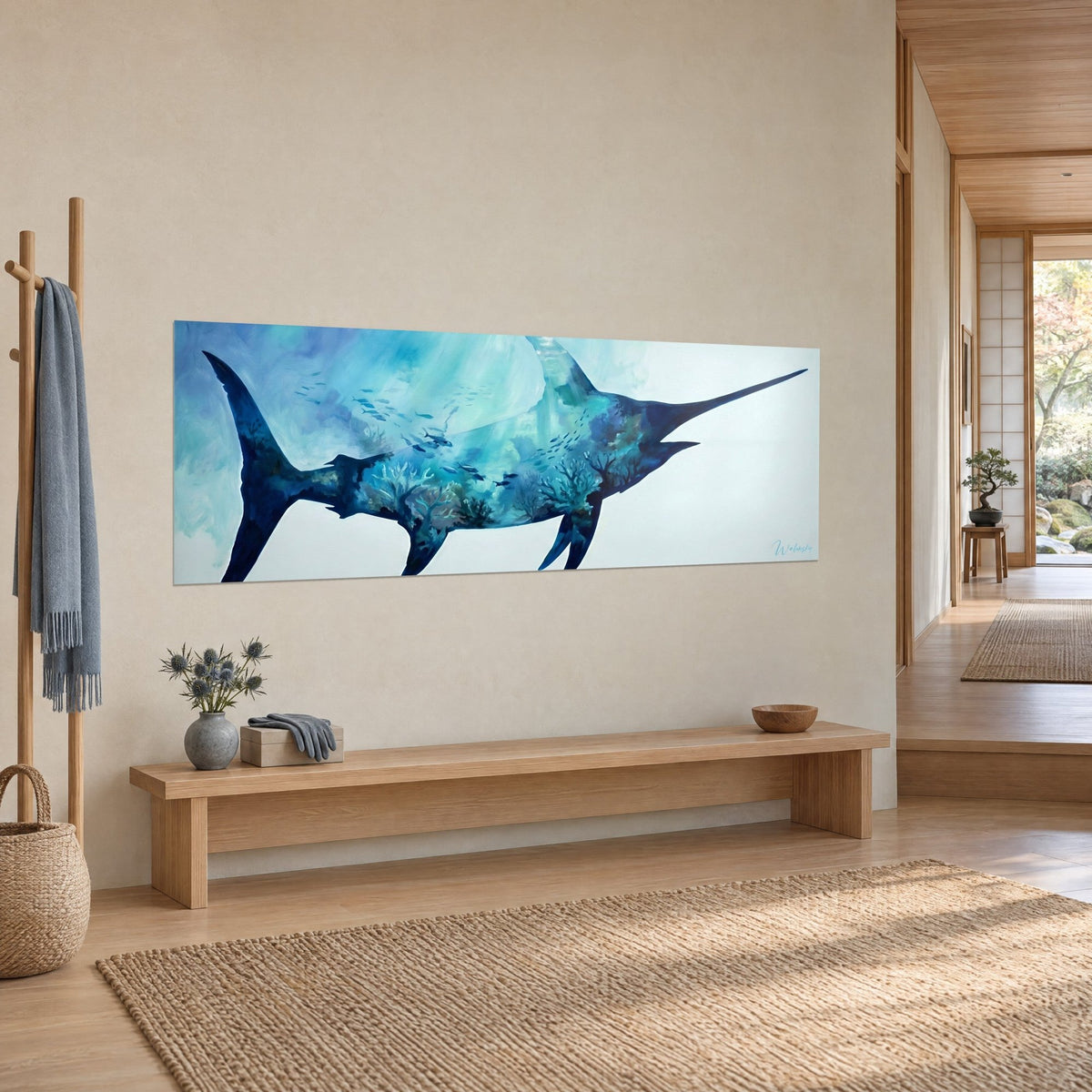 Wall art billfish silhouette in midnight blue and icy white, coral reefs faintly visible in the background, on a beige wall beside a wooden bench