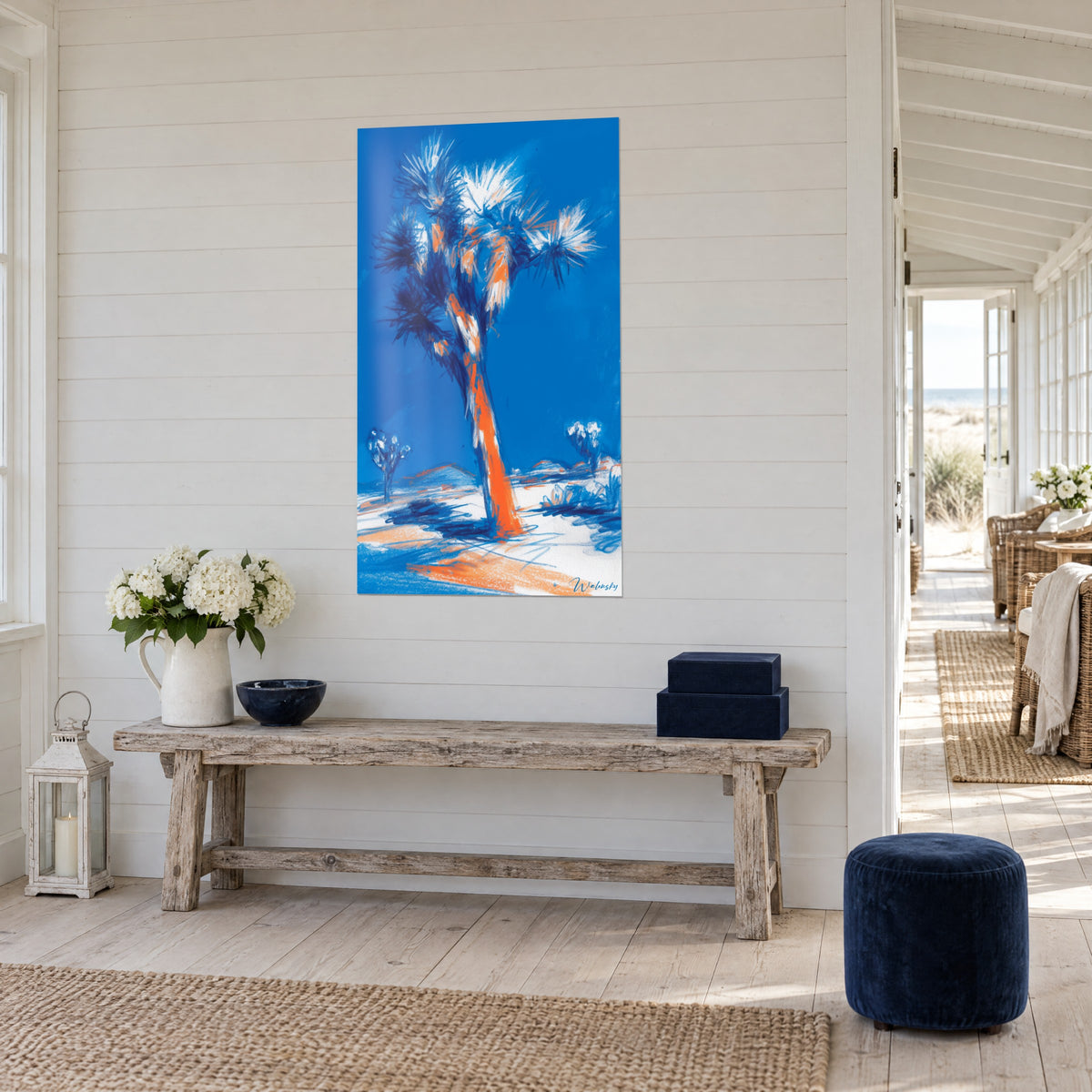 Wall art giant yucca with an orange trunk and ultramarine blue sky, three-quarter view, wooden bench and flowers, seaside house