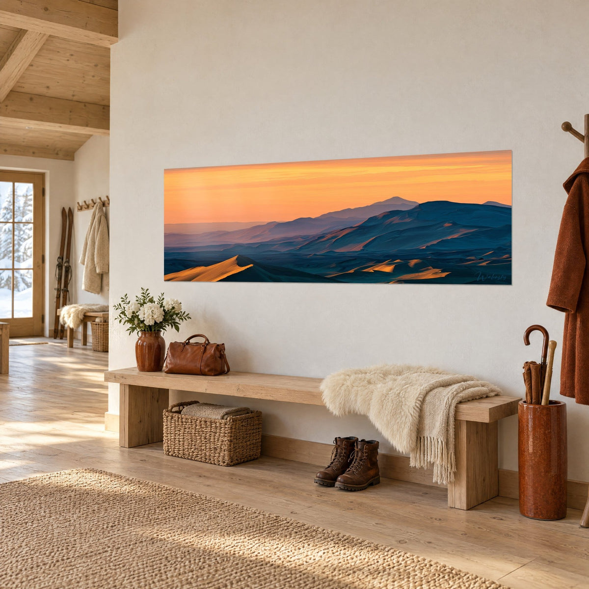 Wall art mountain panorama in indigo gradient, apricot sky and amber-lit flanks, hung in a chalet entryway