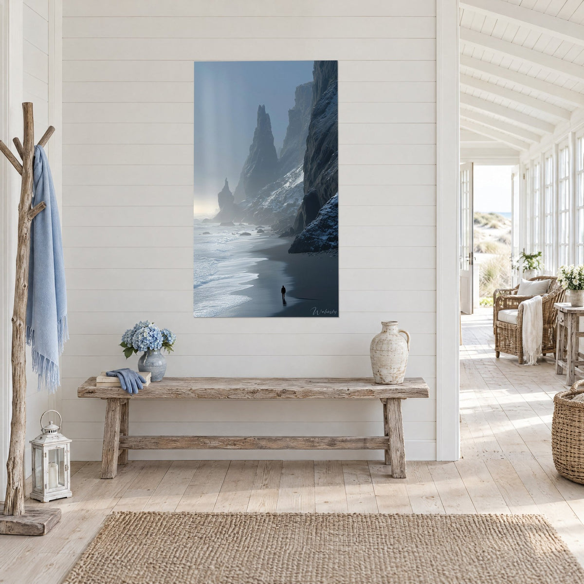 Wall art frosted rock needle and black sand beach, grey-blue sky, hung at an angle in a seaside house