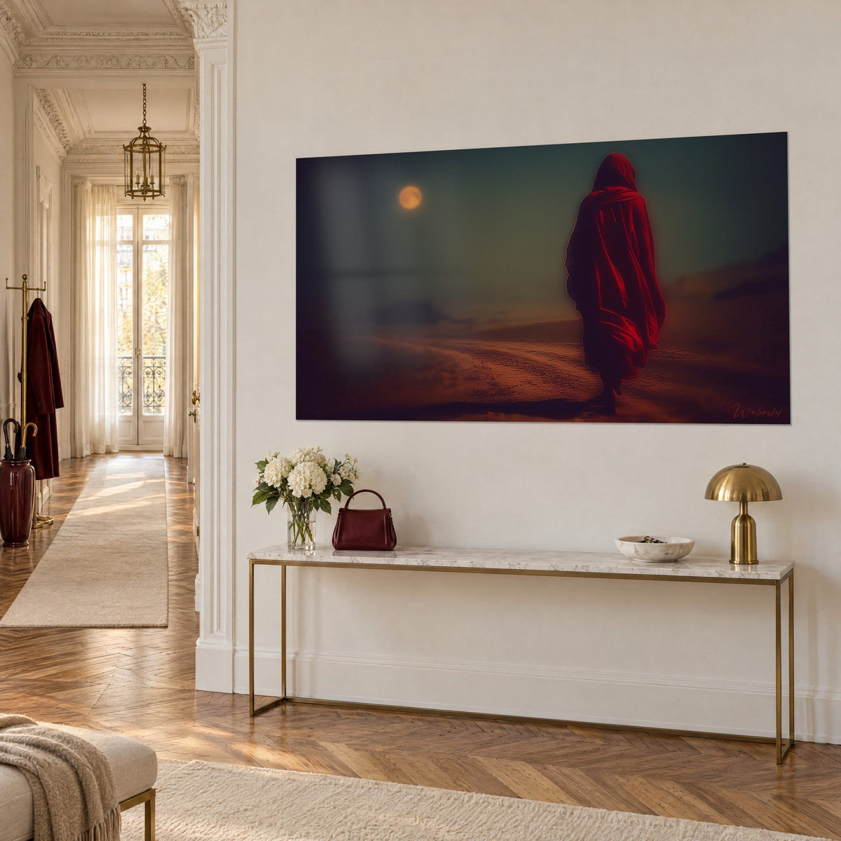 Wall art of a crimson hooded pilgrim striding through the dunes, copper moon, grey-green sky, gilded console in three-quarter view