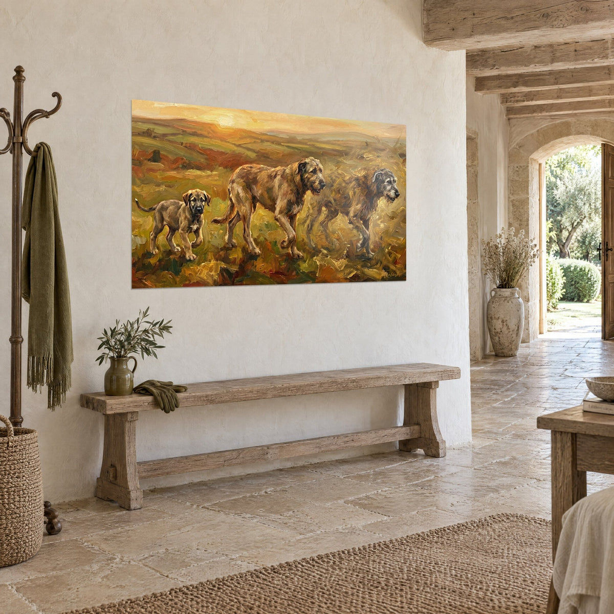 Wall art of three rough-coated hunting dogs on a family walk, ochre and olive green hills, wooden bench, stone house