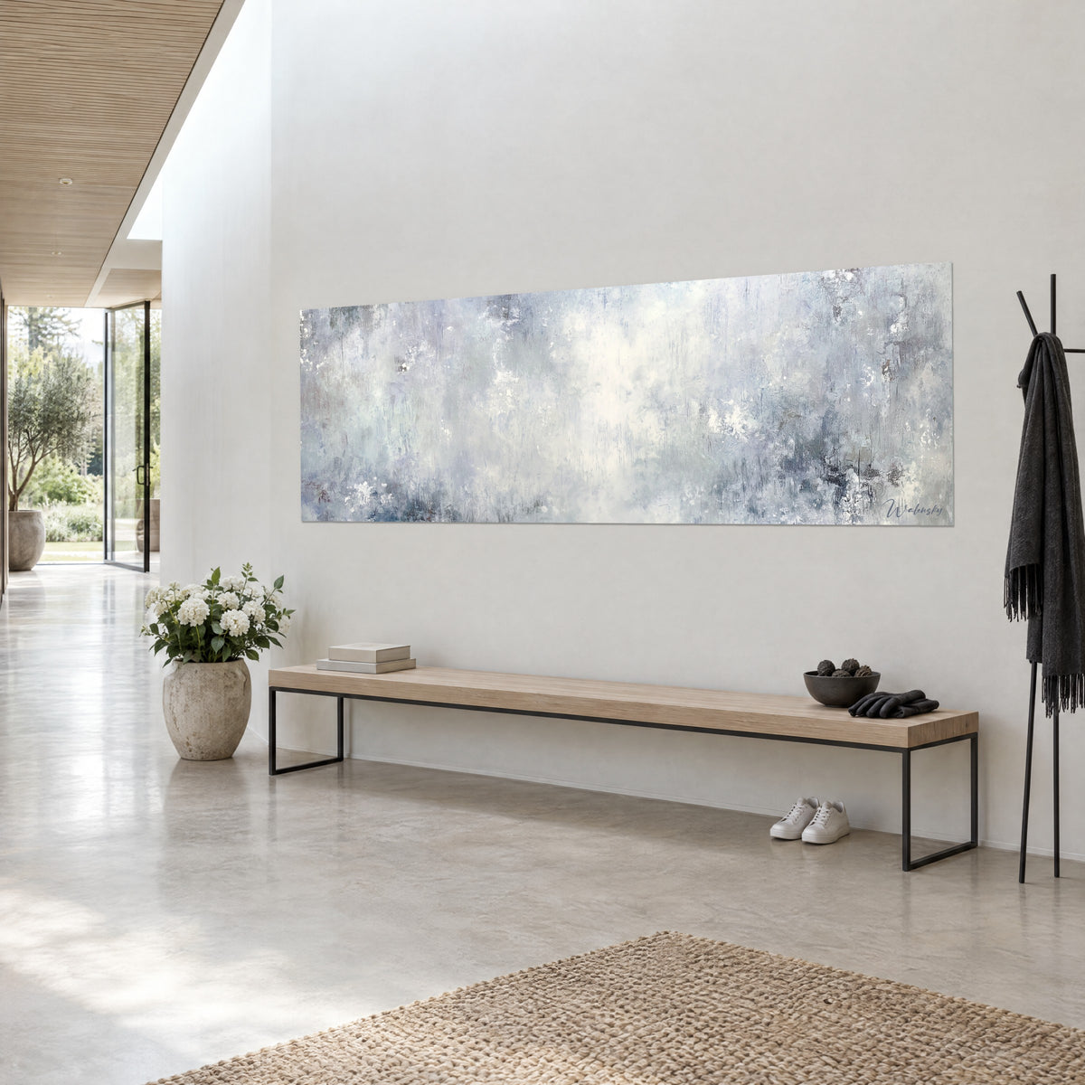 Quadro di cielo astratto in lunghezza, impasti bianchi e grigio ardesia, visto di tre quarti in un ingresso chiaro di casa d'architetto