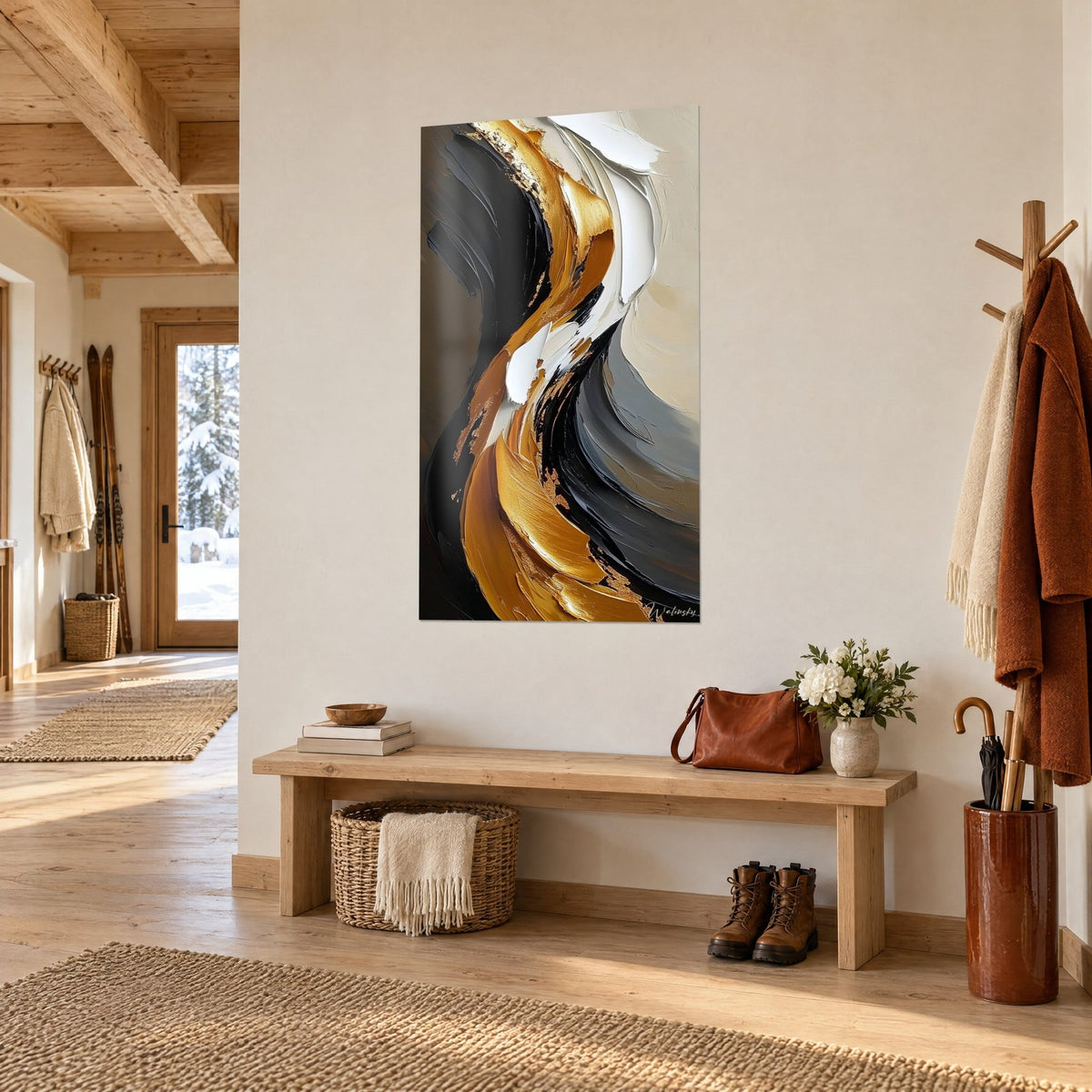 Wall art with sculpted gold ribbon in thick impasto on black and beige background, three-quarter view above a bench in a chalet entryway