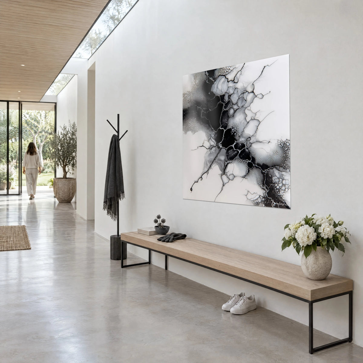 Wall art monochrome blend with silver veining on ivory and ebony background, seen at an angle in a corridor lit by a glass roof