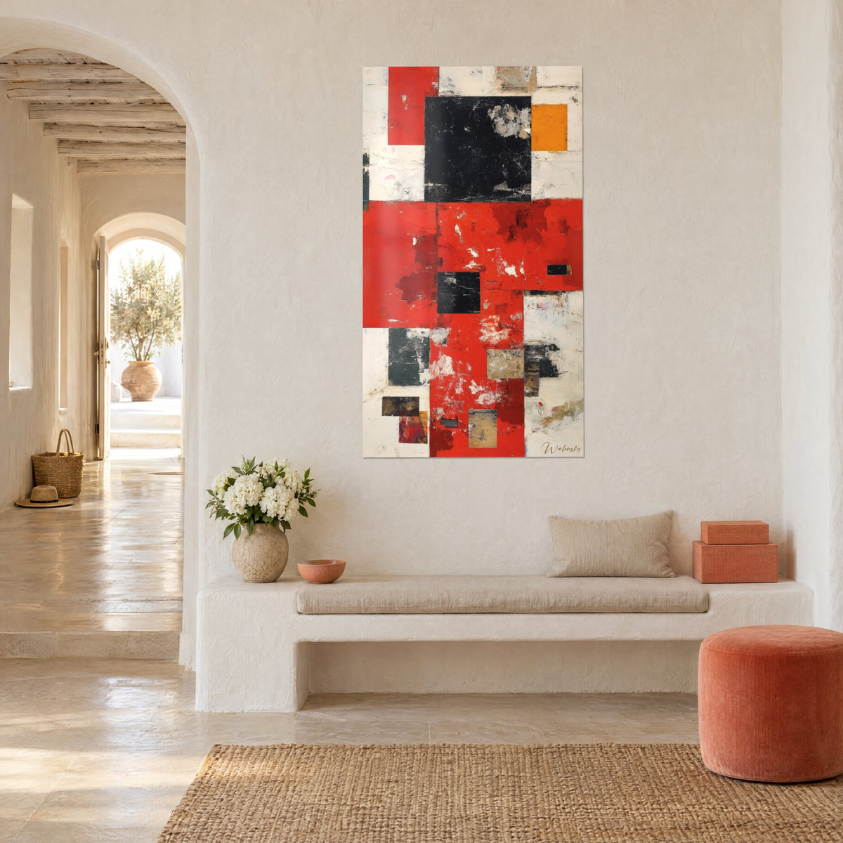 Tableau composition de carrés écarlates, noirs et orangés sur fond crème, mur blanc voûté, banquette en pierre et pouf corail