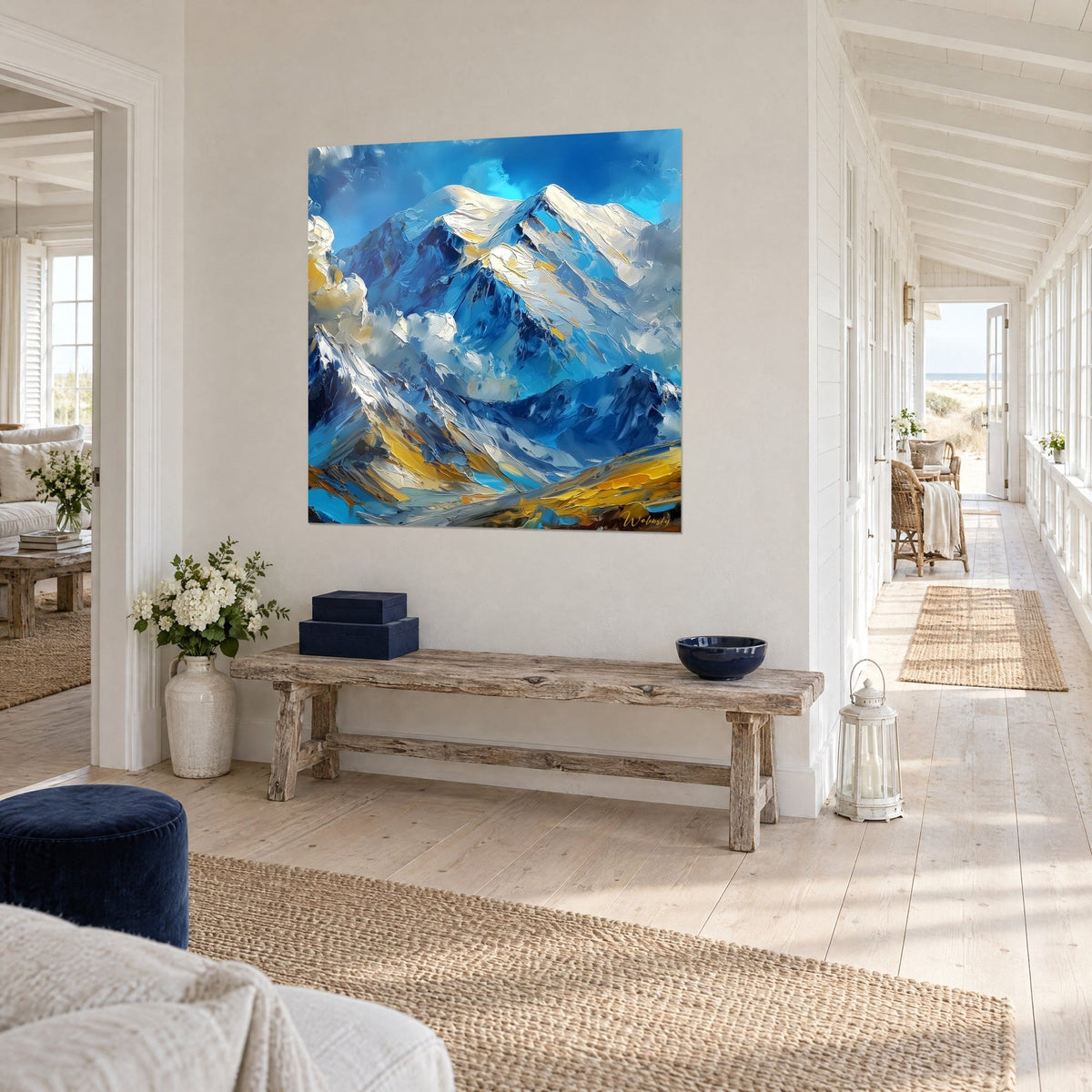 Wall art chain of frosted peaks painted in thick palette-knife strokes, ultramarine blue and cream white, angled view in a bright hallway