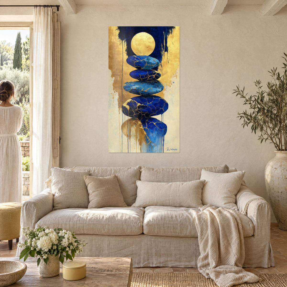 Wall art of a stack of cobalt blue pebbles, cracked and veined with gold, under a golden moon, above a sofa in a bright living room