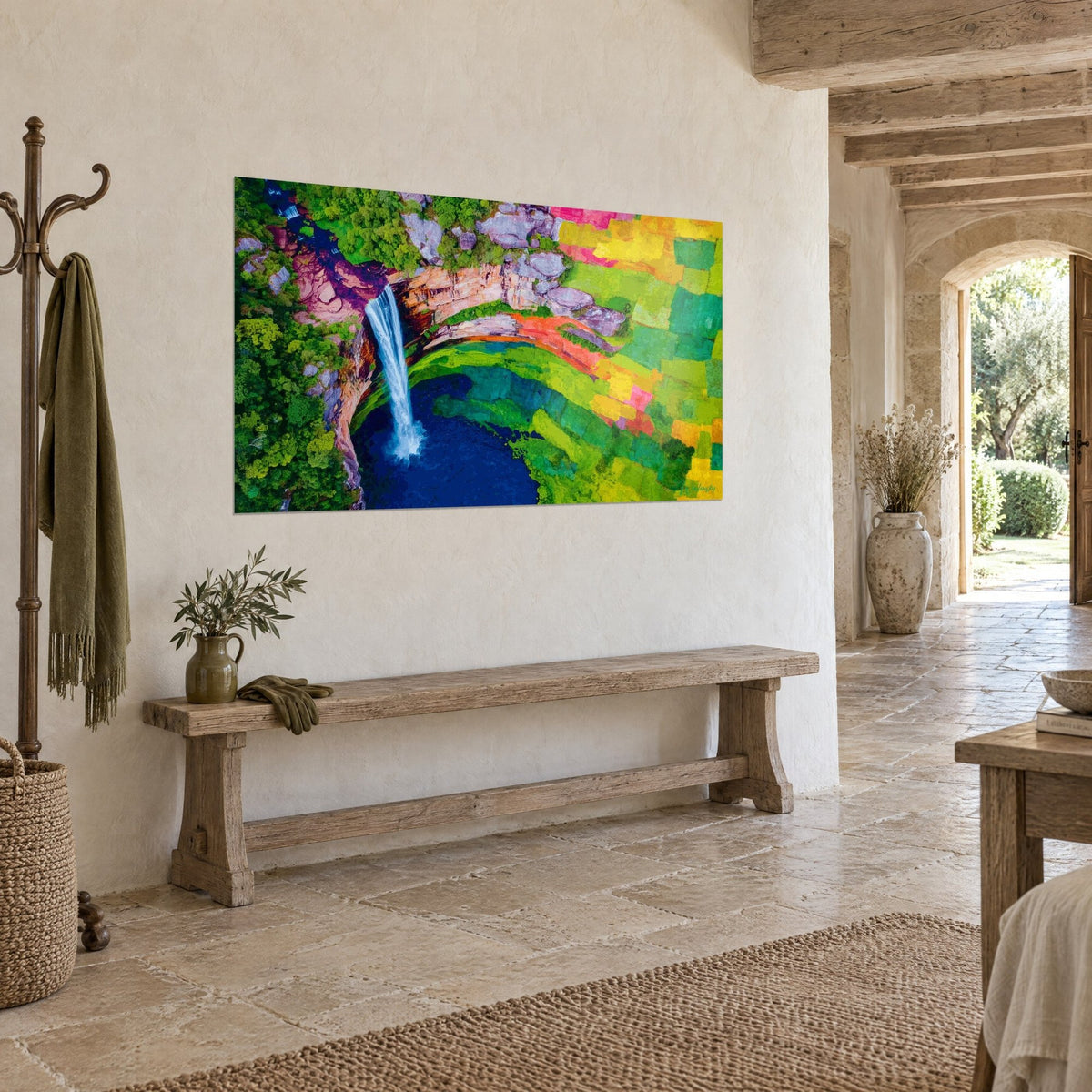 Wall art cascade falling from a pink and ochre cliff, mosaic of green and yellow plots, stone wall, rustic bench