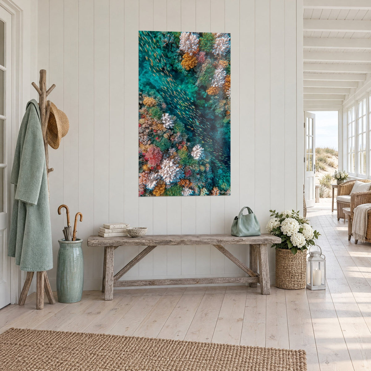 Wall art amber fish swimming between white and pink corals on turquoise water, in a seaside house hallway