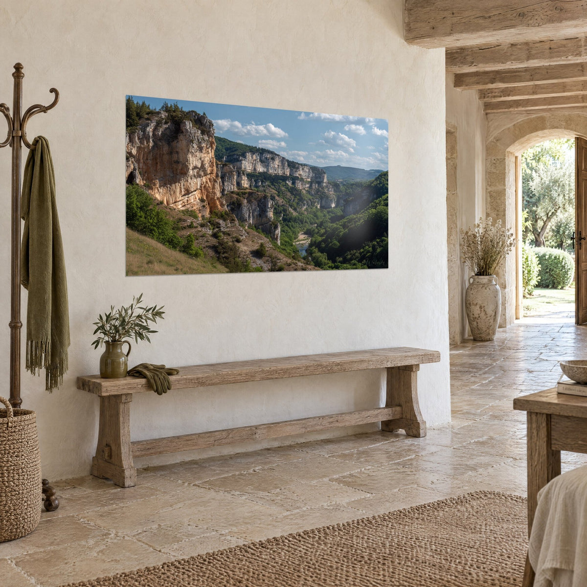 Wall art wild gorges with golden rock walls and deep green forest, river below, hung at a three-quarter angle above a wooden bench