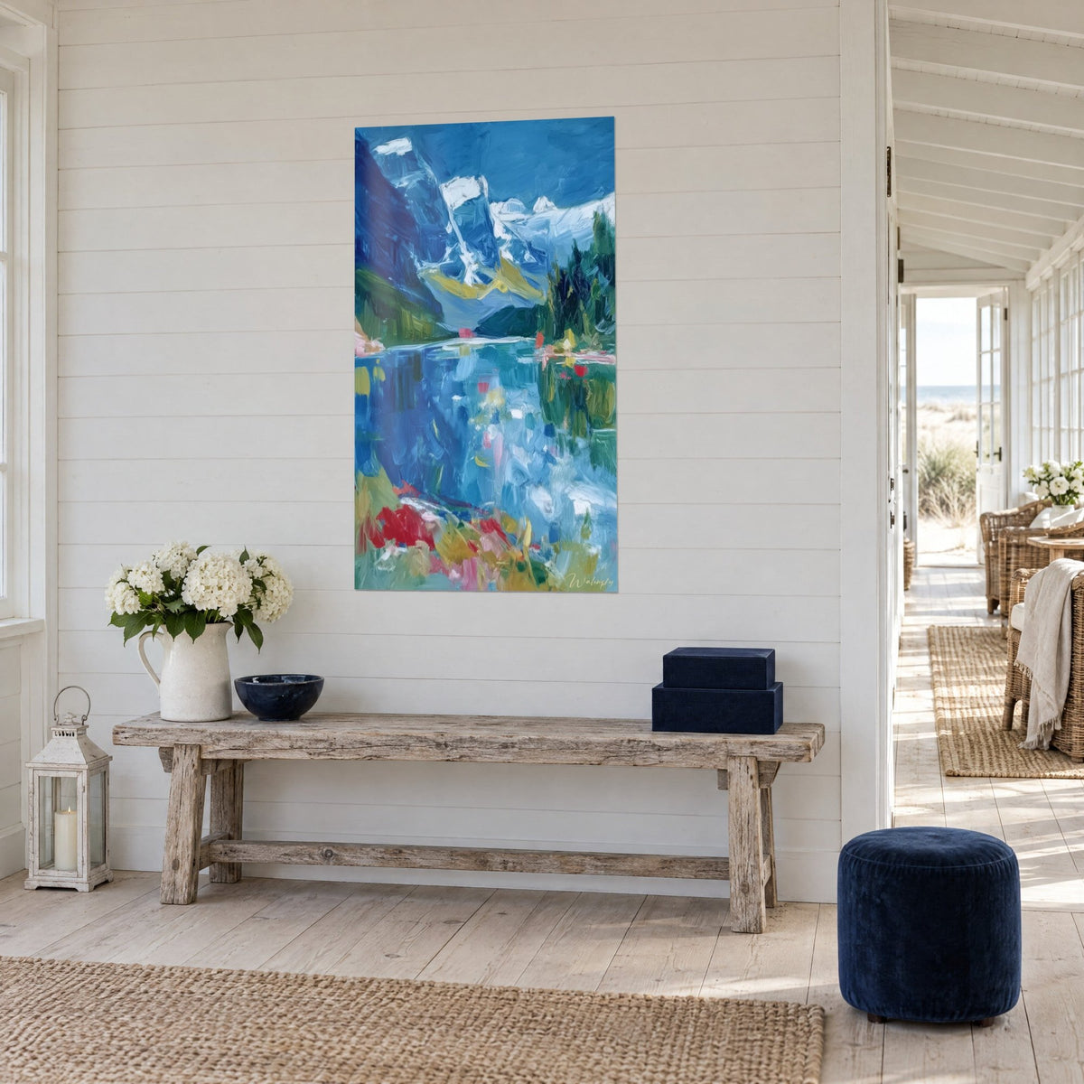 Wall art white peaks mirrored in turquoise water, green firs and yellow touches, three-quarter view in a seaside living room