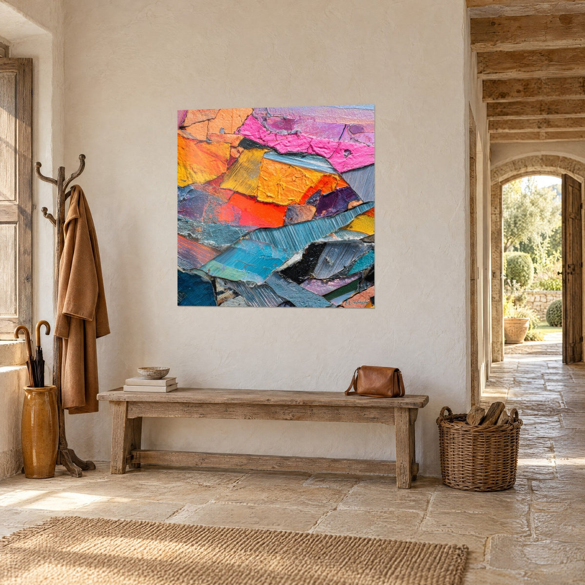 Wall art mosaic of mustard yellow and fuchsia paint flakes, hung on a stone wall beside an arch