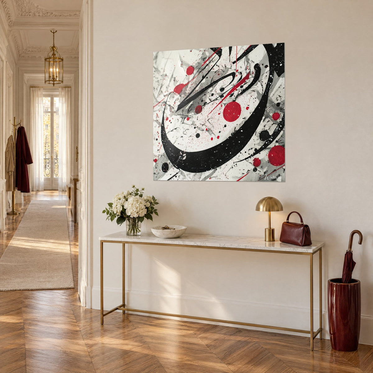Tableau toile d'éclaboussures noires, rouges et grises, grand cercle d'encre sur mur crème, vu de trois quarts au-dessus d'une console dorée