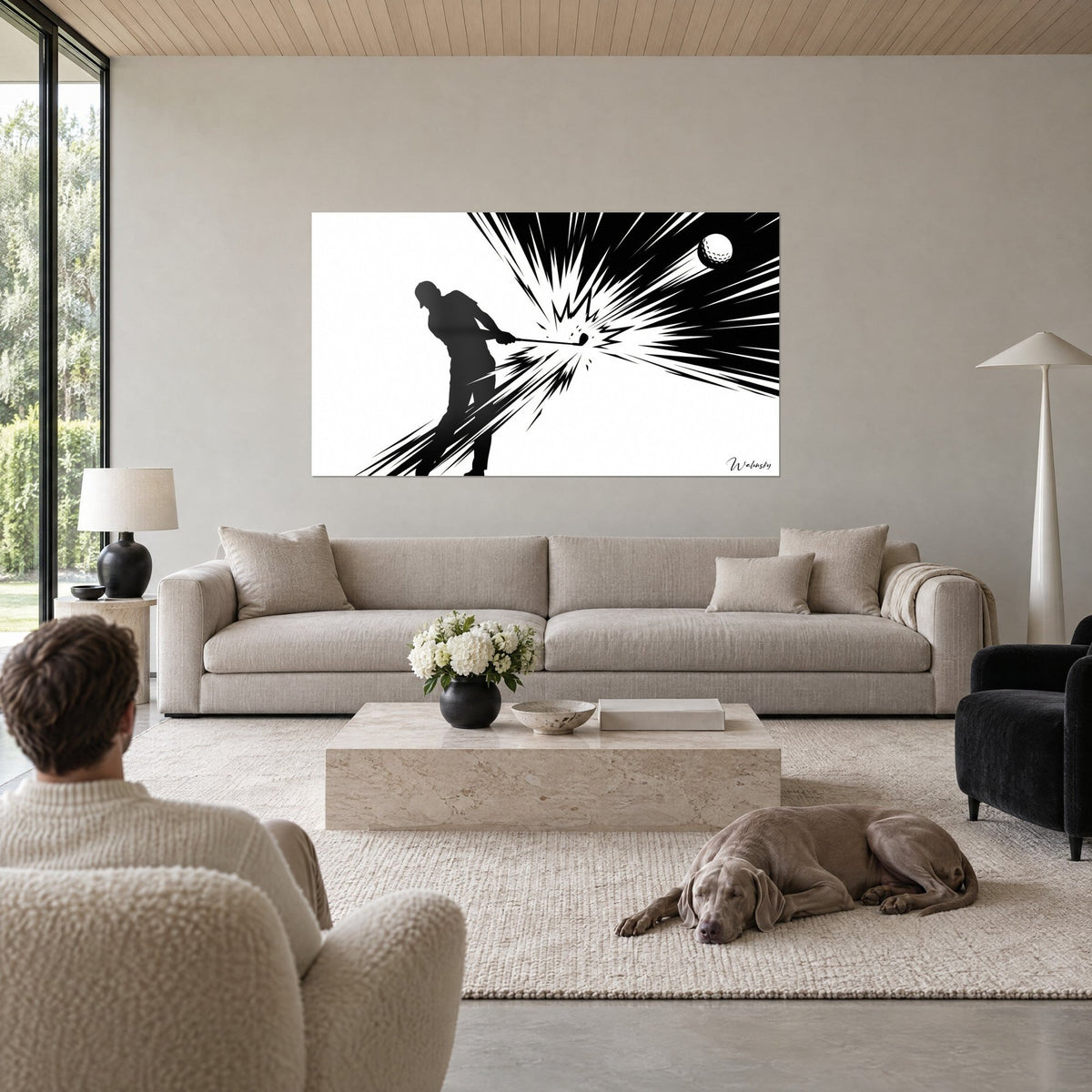 Tableau golfeur en silhouette noire frappant sa balle dans une gerbe d'éclats sur fond blanc, au-dessus d'un canapé dans un salon lumineux