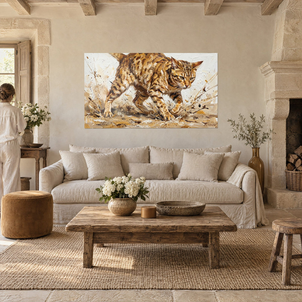 Wall art of a spotted wild cat lunging through ochre and cream splashes, above a sofa in a bright living room