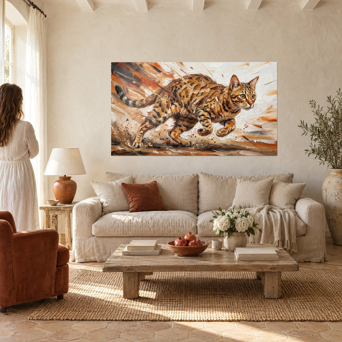 Wall art of a spotted wild cat leaping in ochre and burnt orange, palette-knife strokes on ivory background, above a sofa in a bright living room