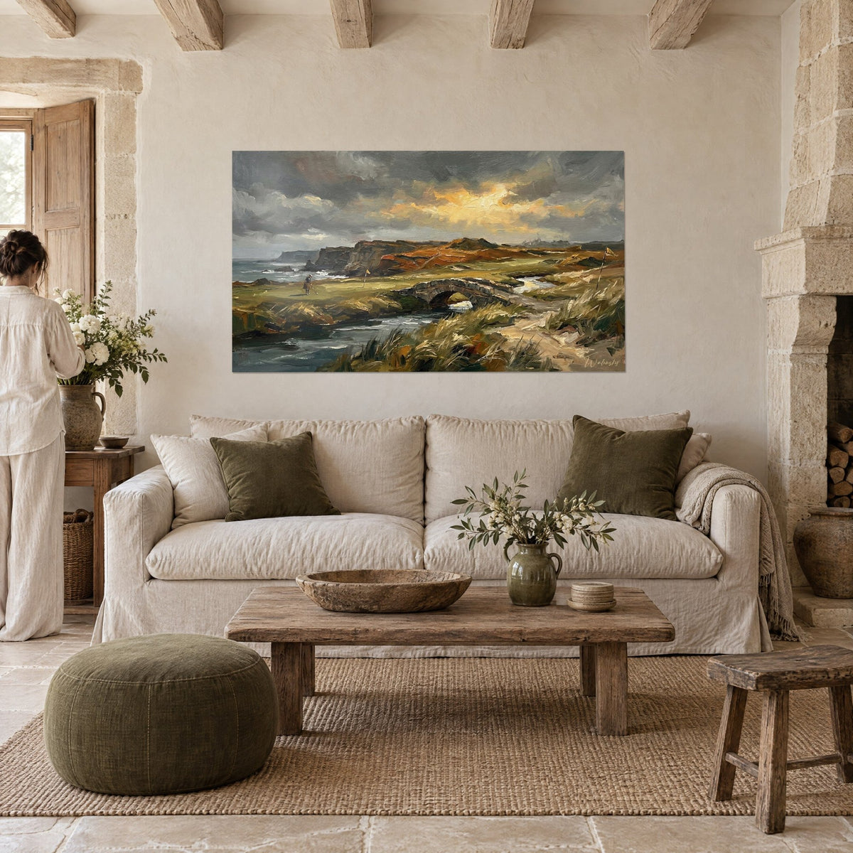 Wall art Scottish golf course under a golden stormy sky, ochre cliffs and stone bridge, above a sofa in a bright living room