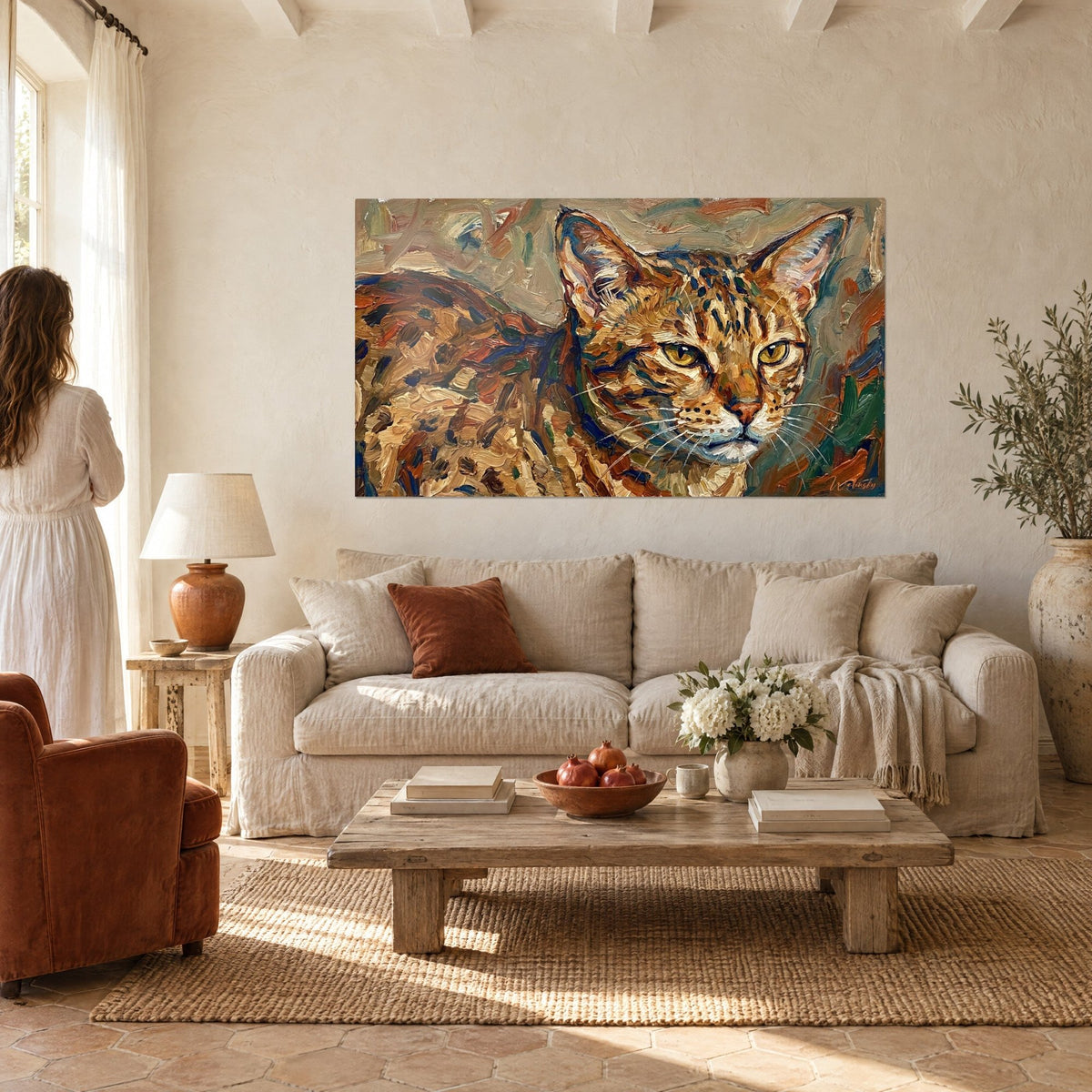 Wall art Ocicat cat with golden eyes, midnight blue and orange speckled coat, above a sofa in a bright living room