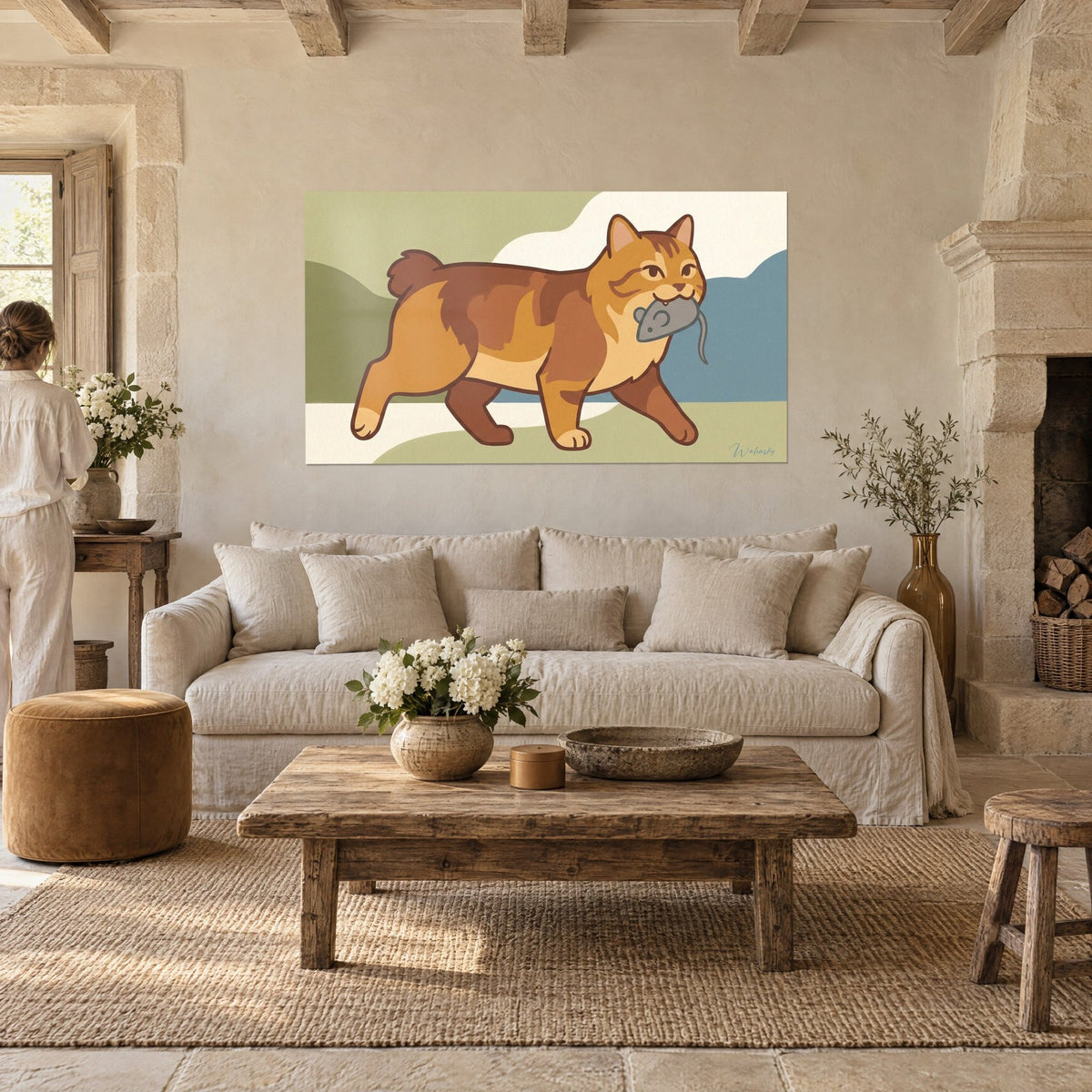 Wall art of a ginger and brown tabby cat trotting with a grey mouse in its jaws, sage green and slate blue background, above a sofa in a bright living room