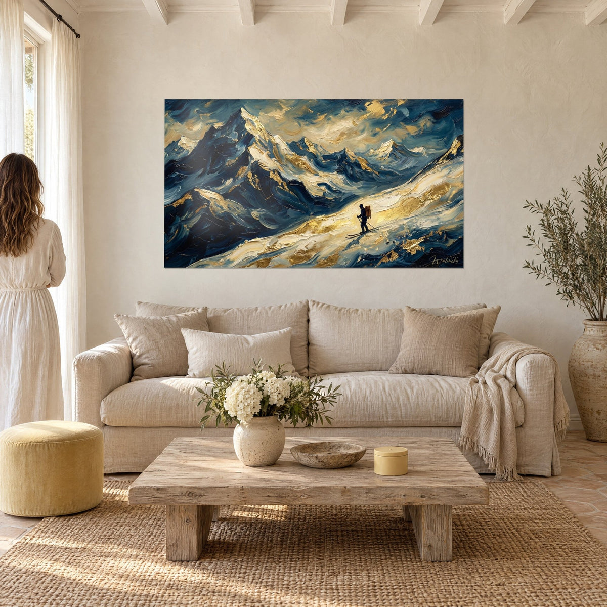 Wall art of a lone skier on a snowy ridge, midnight blue and gold, thick impasto, above a sofa in a bright living room