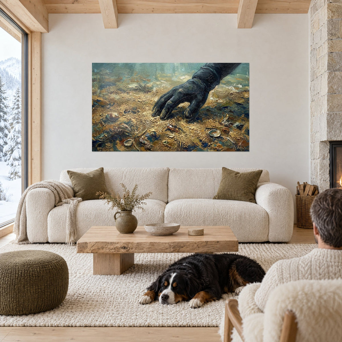 Wall art of a black diving glove grazing golden sand, bluish seashells, a dog lying down, above a sofa in a bright living room