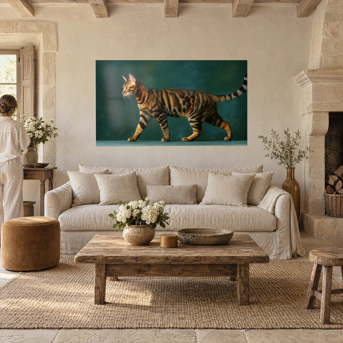 Wall art of a Toyger cat walking, orange coat striped with black on a fir green background, hanging above a sofa in a bright living room