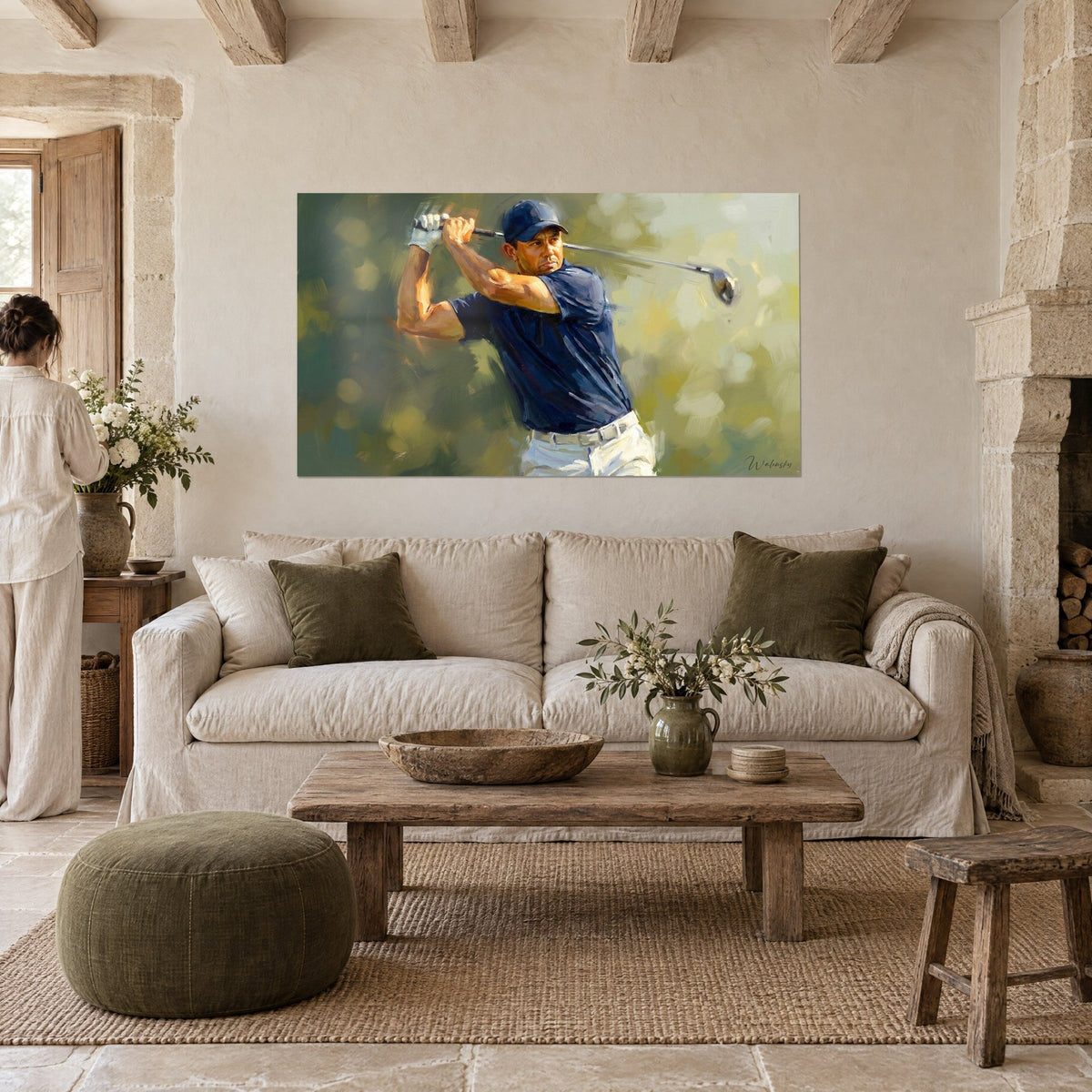 Wall art of a golfer mid-swing, navy polo and white trousers against an olive green background, above a sofa in a bright living room