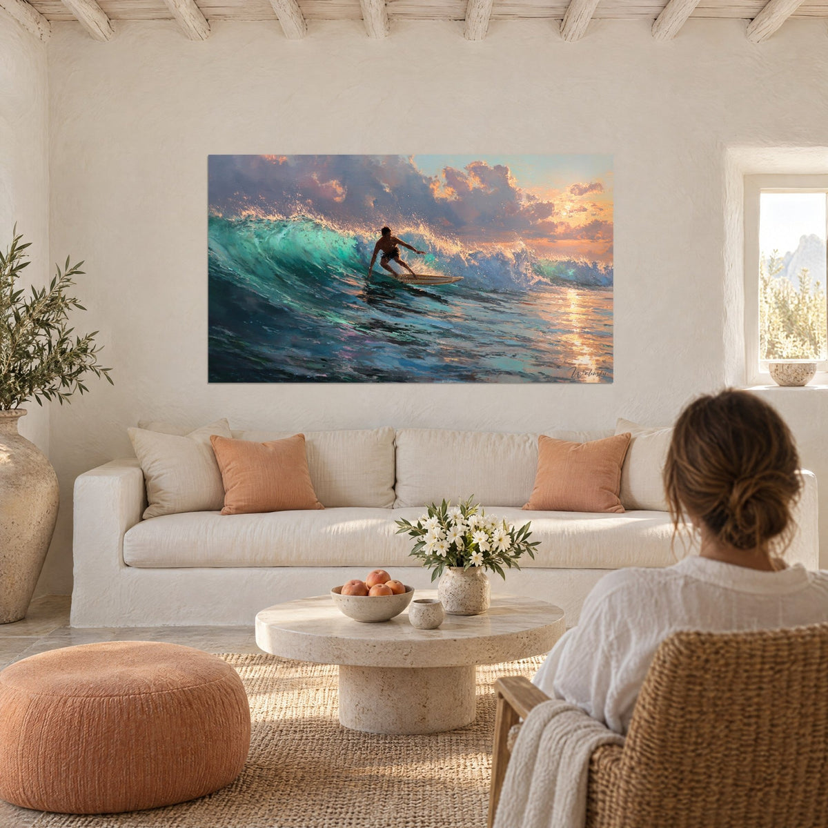 Wall art surfer riding his cream board in a turquoise wave, rosy and golden clouds, above a sofa in a bright living room