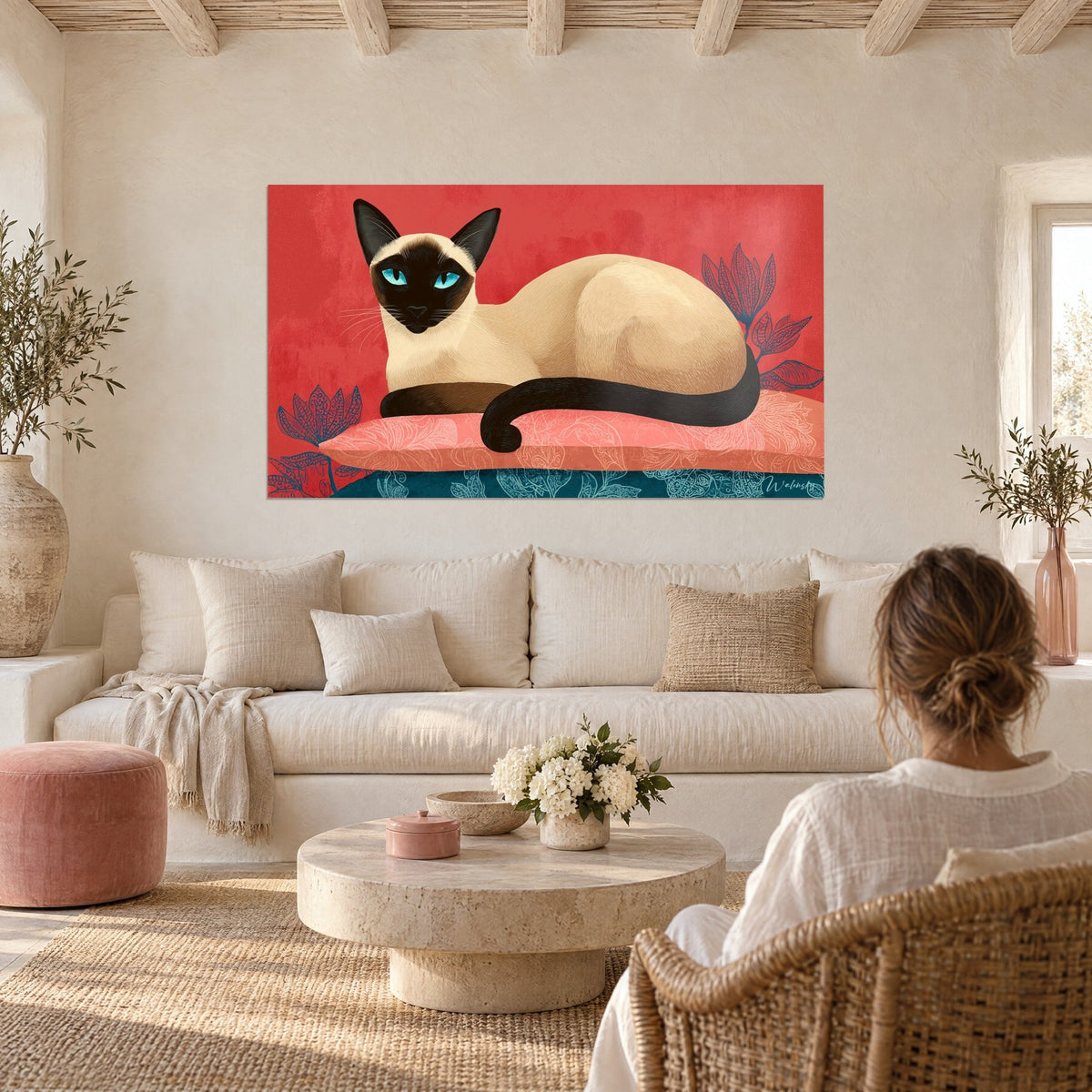 Wall art Siamese cat with turquoise eyes, lying on a coral cushion in front of a red background, above a sofa in a bright living room