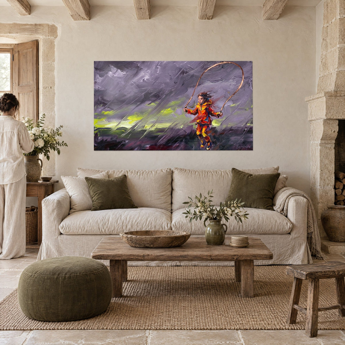 Wall art girl skipping rope in orange waxed fabric under a violet sky, hung above a sofa in a bright living room