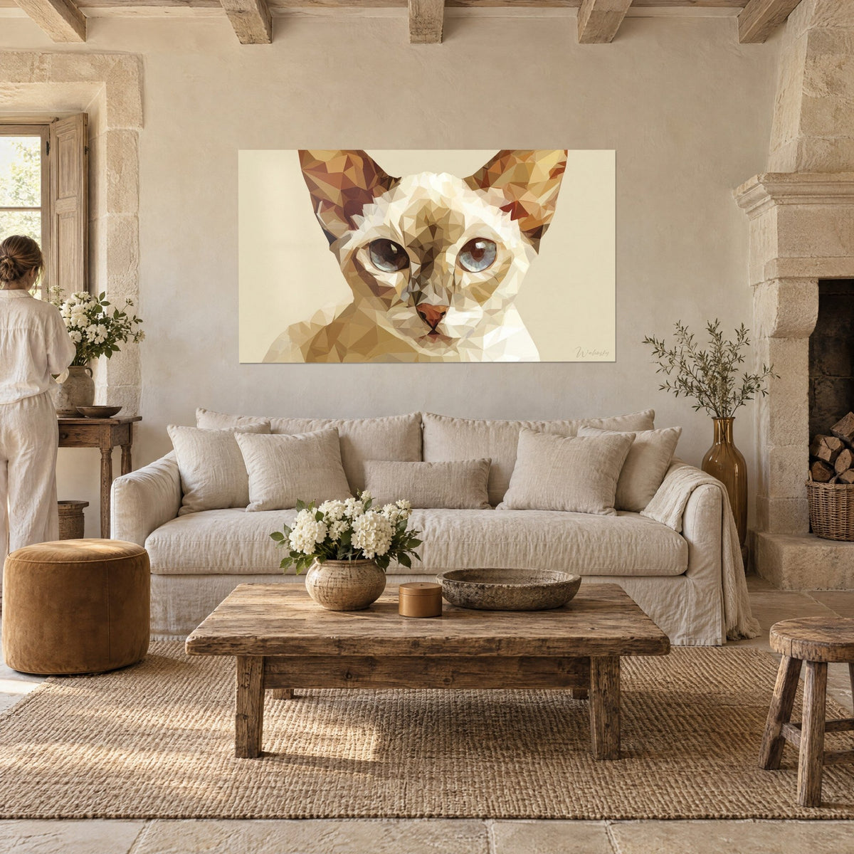 Wall art Singapura cat in ochre and ivory facets, grey-blue eyes, person seen from behind, above a sofa in a bright living room