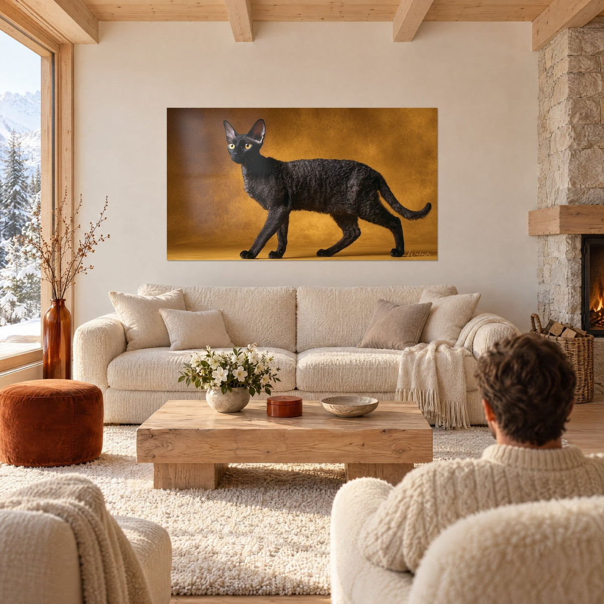 Wall art black curly Cornish Rex cat with golden eyes on an ochre background, in front of a cream sofa, above a sofa in a bright living room
