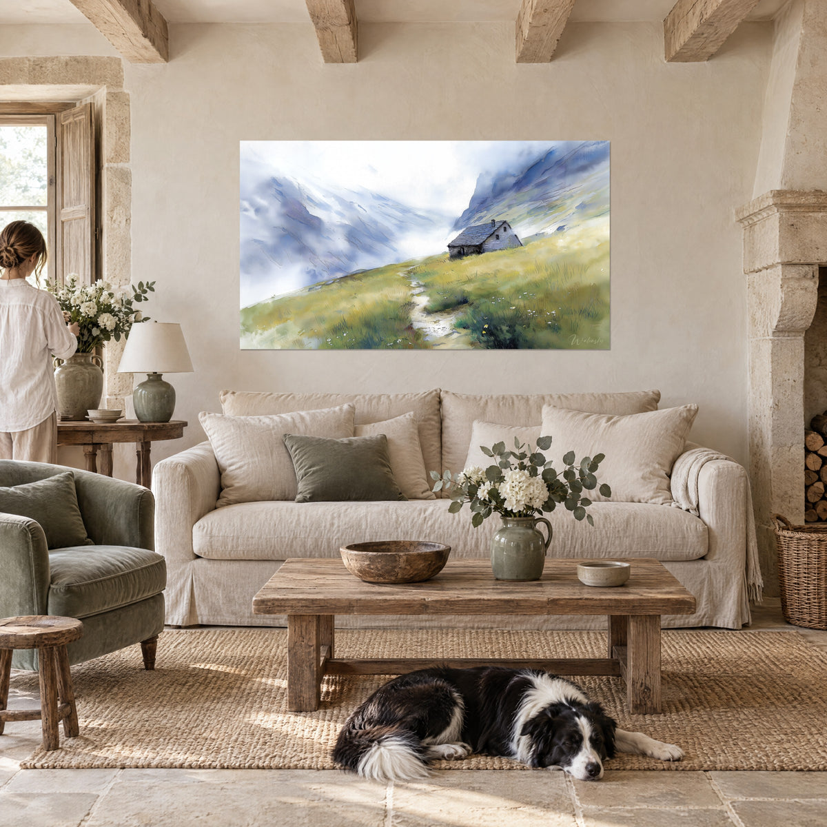 Wall art grey stone mountain hut in the mist of the peaks, yellow grass and white sky, above a sofa in a bright living room