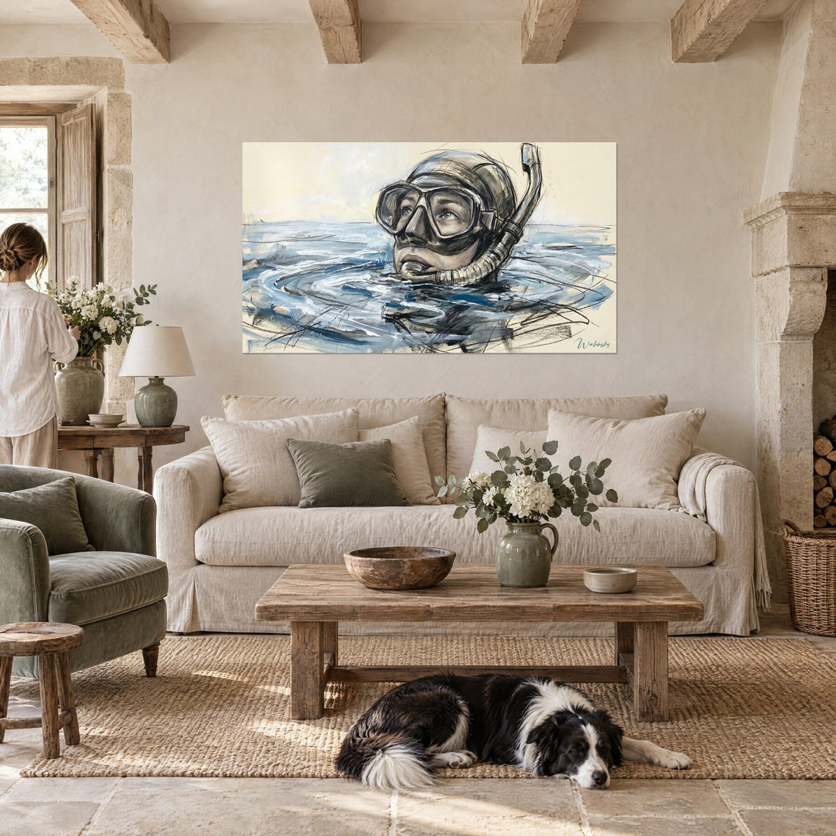 Wall art of a diver with a charcoal-outlined mask emerging from steel-blue water, cream background, above a sofa in a bright living room