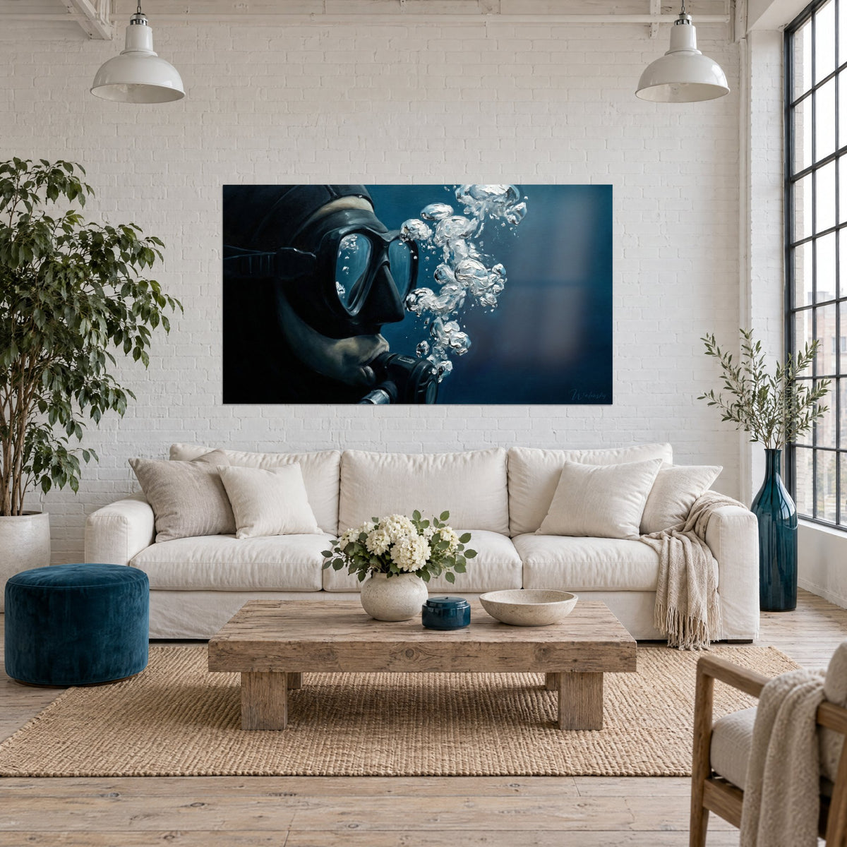 Wall art of a diver in a black mask blowing silver bubbles on a navy blue background, above a sofa in a bright living room