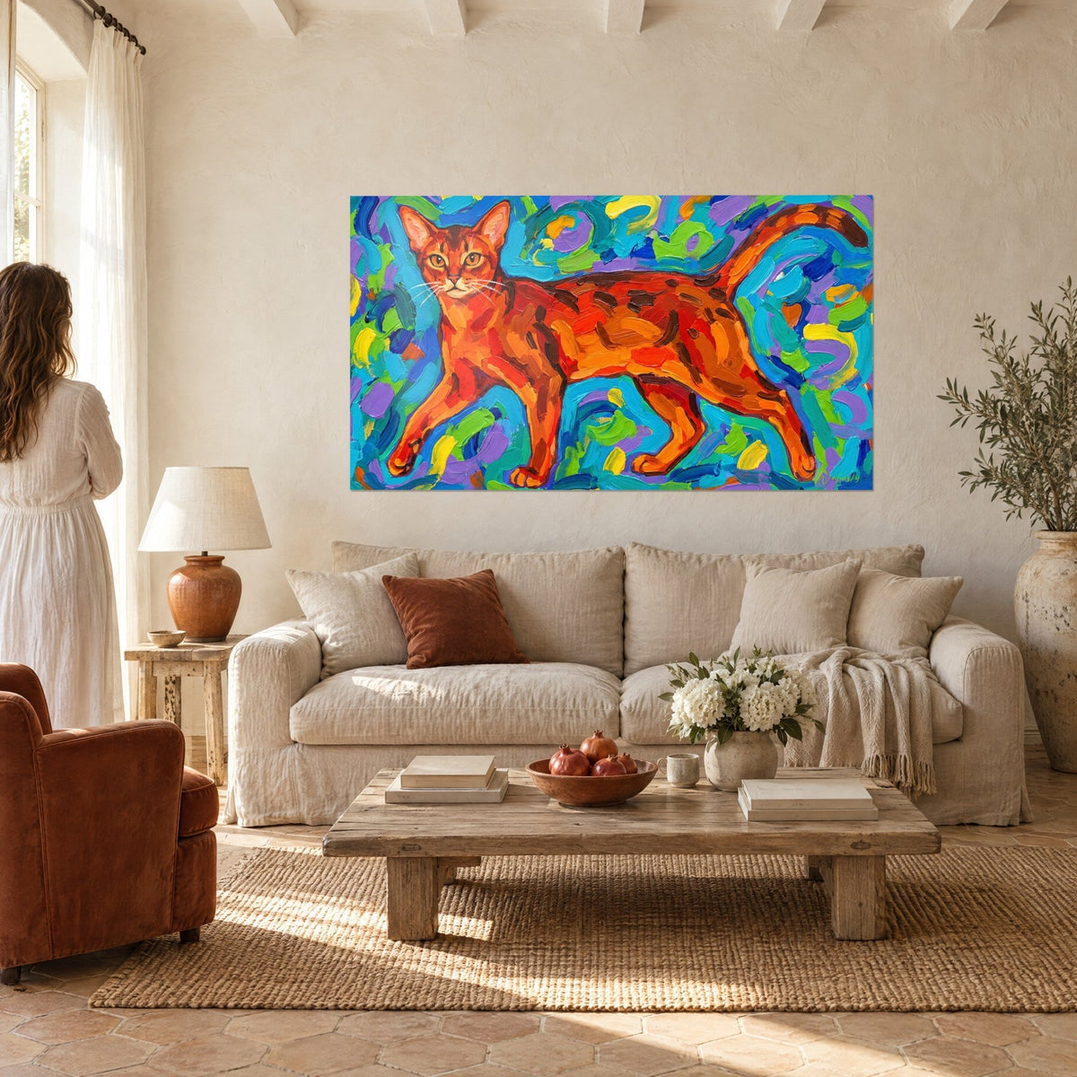 Wall art ginger Abyssinian cat in mid-stride, turquoise and violet background, a woman seen from behind above a sofa in a bright living room