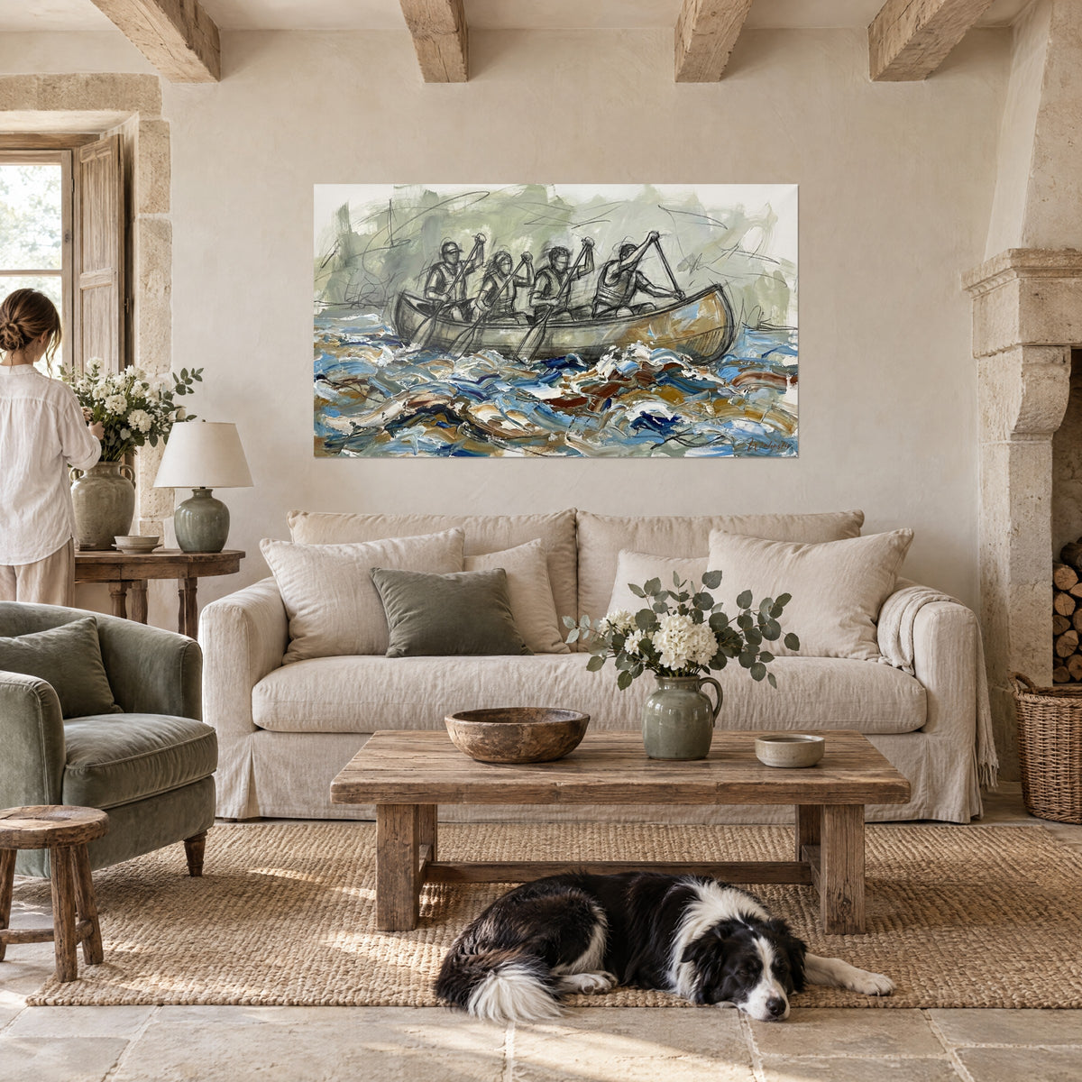 Wall art paddling crew of four canoeists on blue and ochre waves, above a sofa in a bright living room