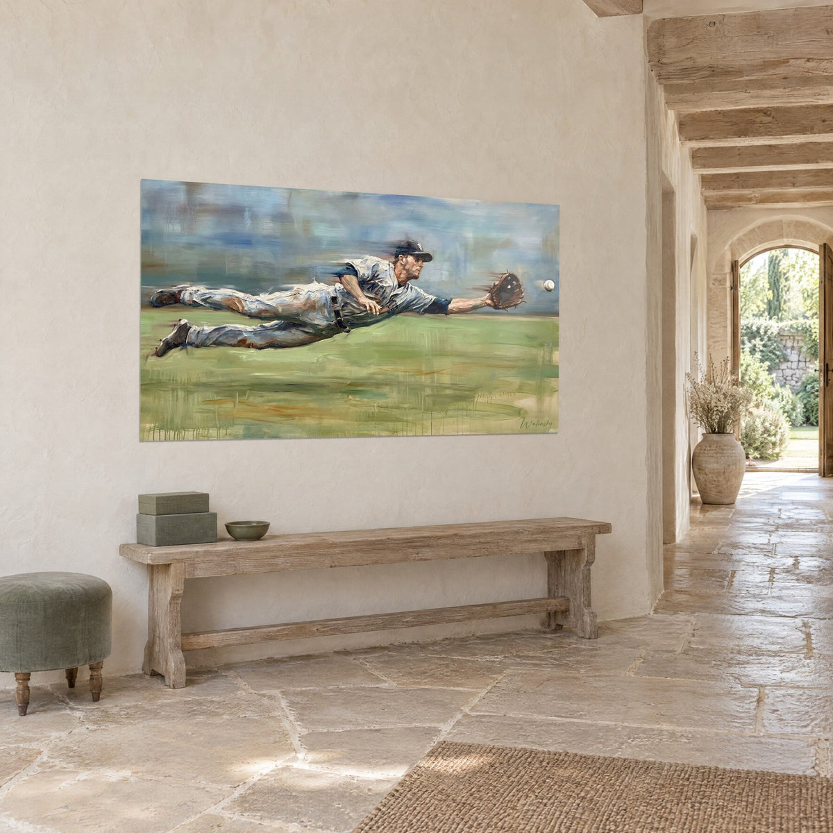 Wall art catcher reaching horizontally toward a white ball, soft green grass and grey-blue sky, on a stone wall