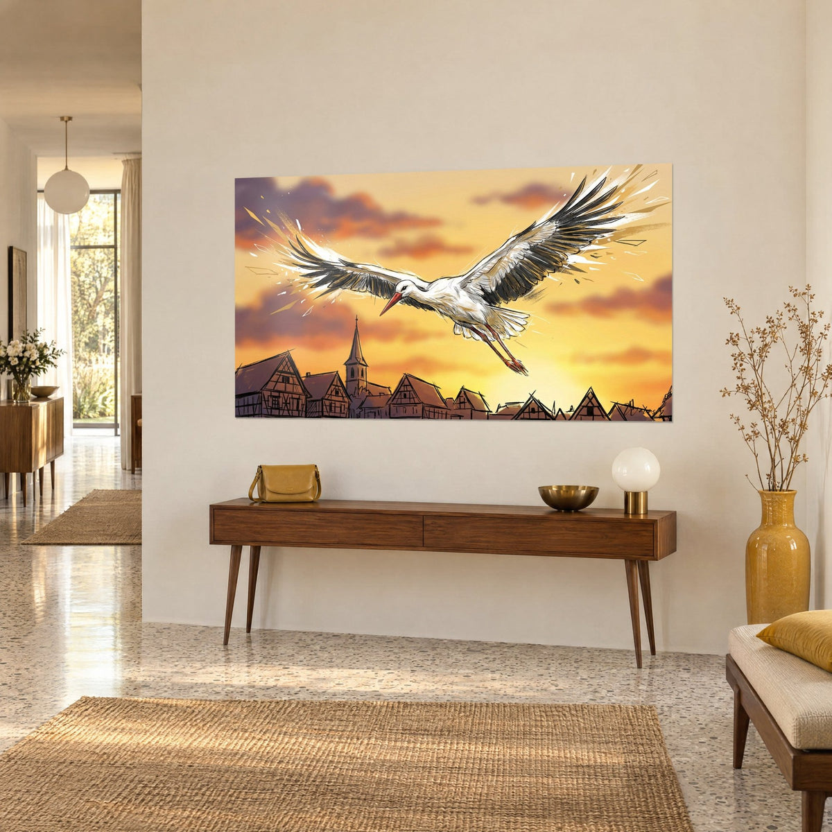 Tableau oiseau échassier au bec rouge planant sur un coucher de soleil doré, clocher et pignons, console en bois dans une entrée