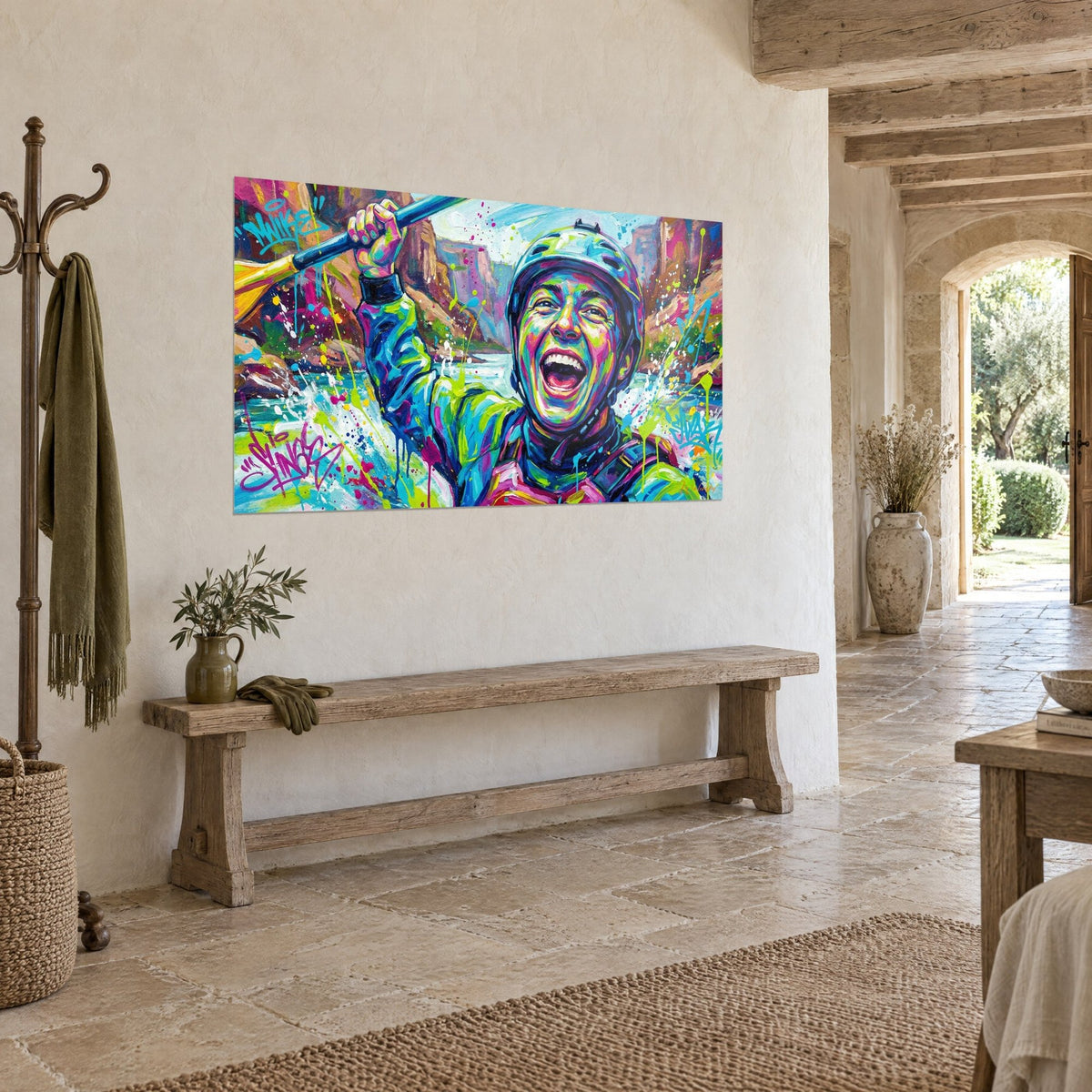 Wall art of a triumphant kayaker with his mouth wide open, fuchsia vest, ochre canyon and turquoise water, mounted on a stone wall in three-quarter view