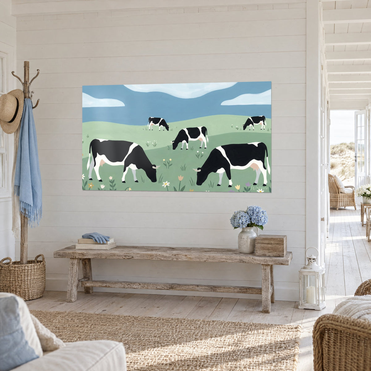 Quadro Mandria di frisone che bruca fiori di campo, prato verde tenue e cielo azzurro, su una parete di legno bianco