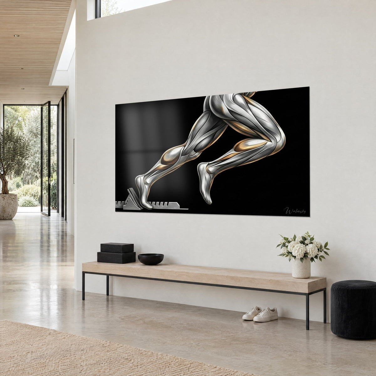Wall art runner's legs in polished steel leaving the starting blocks, grey and gold glints on black, white wall of an architect's house