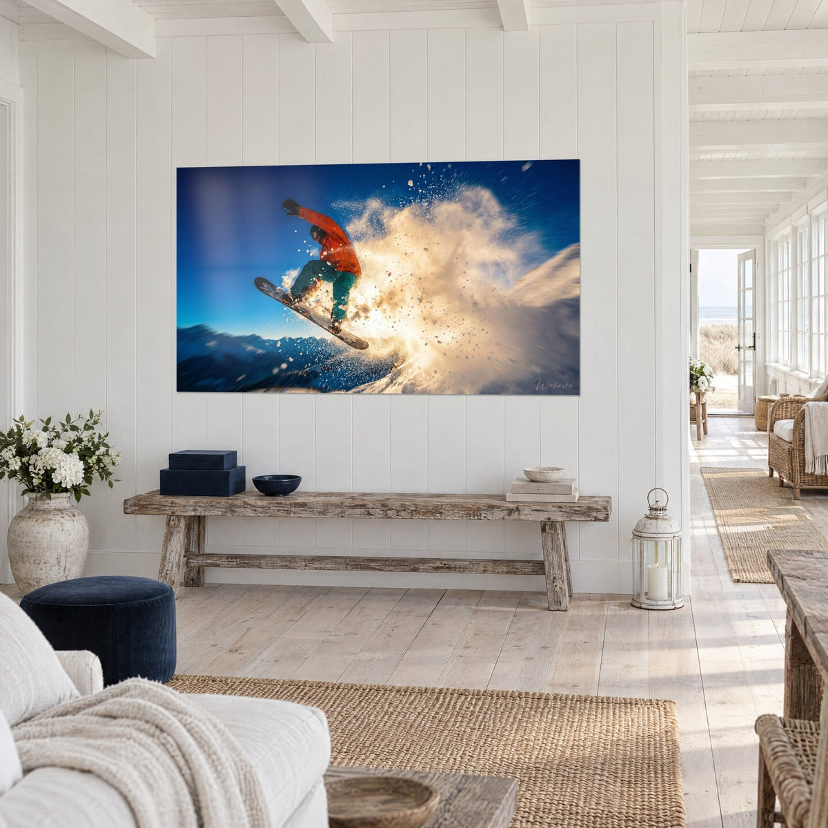 Wall art acrobatic snowboard jump, orange suit and sea-green trousers, amber spray of snow, on a white paneled wall