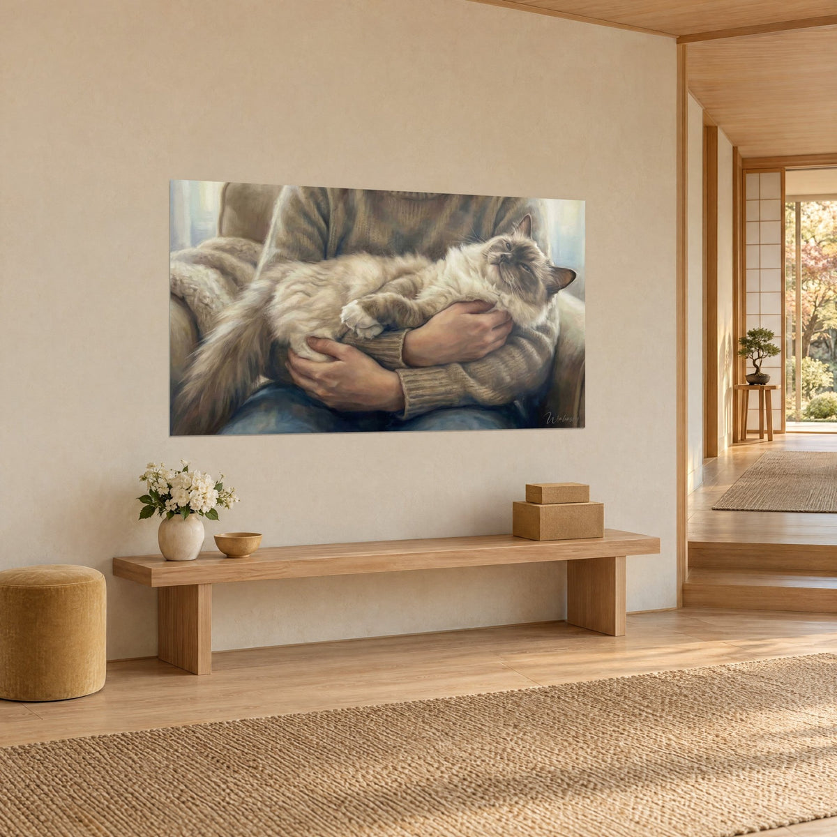 Wall art of an ivory-furred cat with a brown mask, head tilted back on a taupe sweater, hung in a japandi hallway