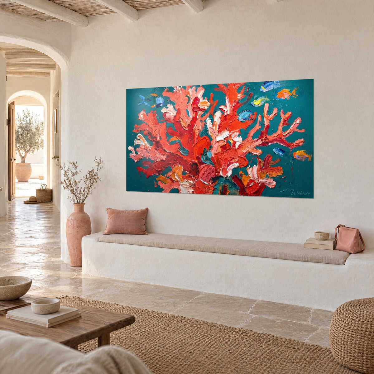 Wall art with vermilion and pale pink coral branches on a teal background, golden fish, hung above a white stone bench
